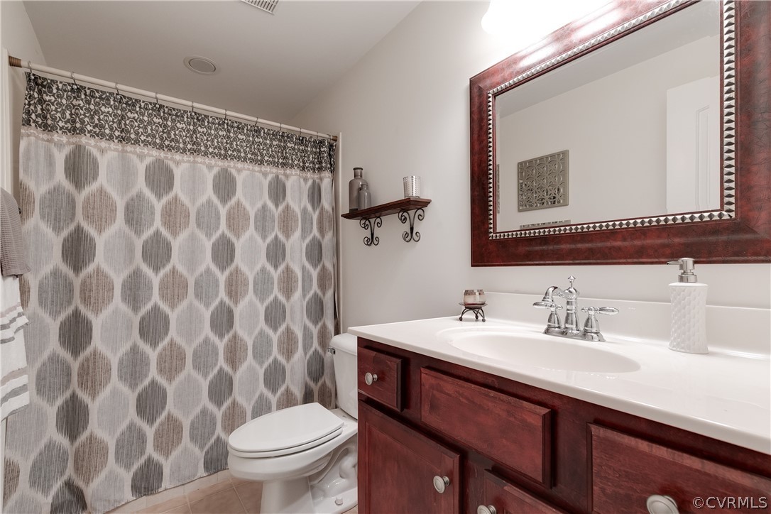 14641 West Salisbury Road Midlothian, VA 23113 - Photo 40 of 50 a bathroom with a granite countertop sink a toilet and a mirror