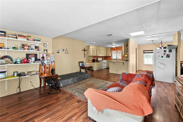 a living room with furniture and a kitchen view