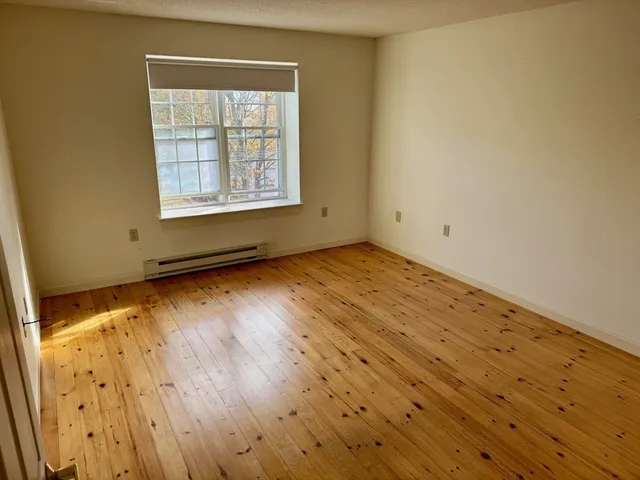a view of an empty room and wooden floor