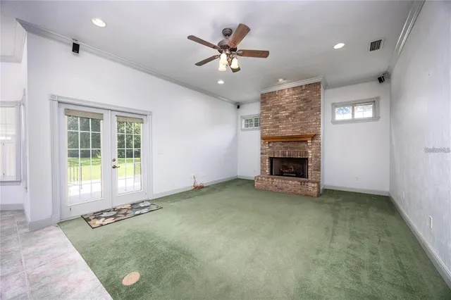 a view of empty room with ceiling fan