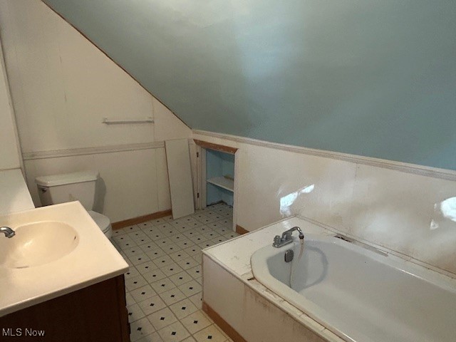 7987 Ridge Road North Royalton, OH 44133 - Photo 25 of 45 Bathroom featuring vanity, a bath, vaulted ceiling, and light floors
