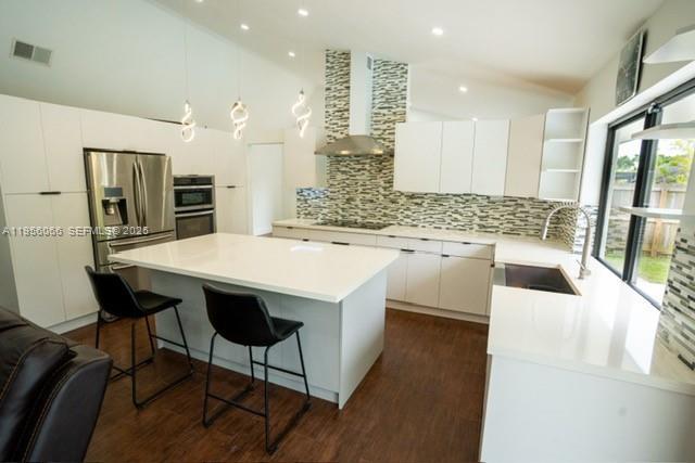10210 Southwest 133rd Court Miami, FL 33186 - Photo 11 of 30 a large kitchen with a table and chairs