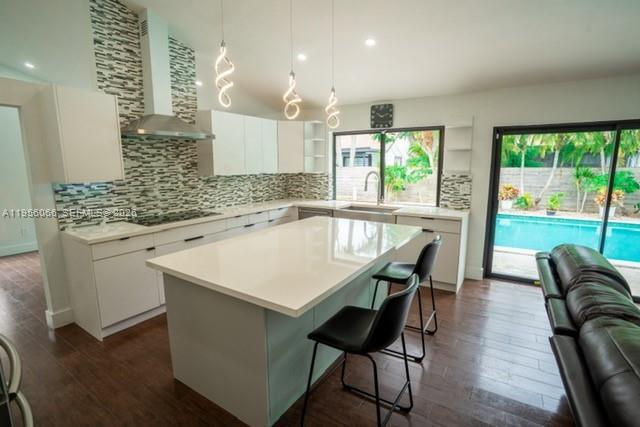 10210 Southwest 133rd Court Miami, FL 33186 - Photo 12 of 30 a kitchen with a table chairs sink and wooden floor