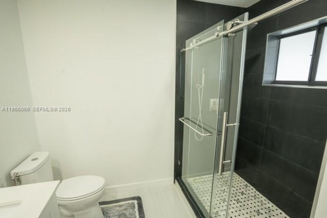 10210 Southwest 133rd Court Miami, FL 33186 - Photo 15 of 30 a bathroom with a shower and a toilet