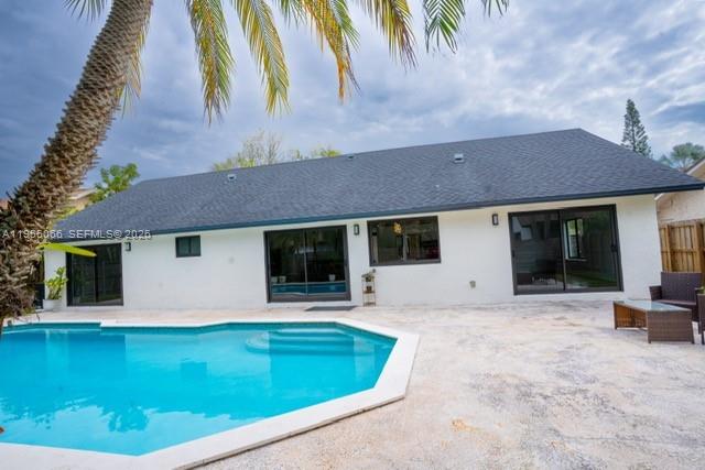 10210 Southwest 133rd Court Miami, FL 33186 - Photo 21 of 30 a view of a house with a swimming pool and sitting area