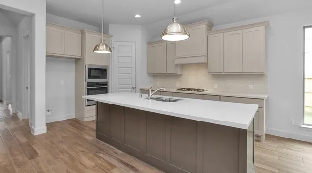 a kitchen with a sink cabinets and window