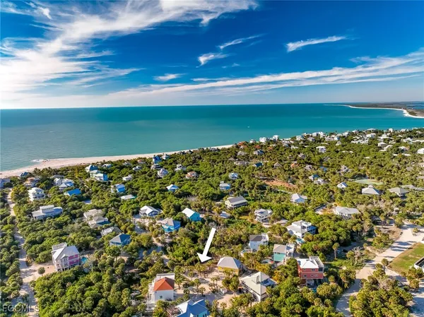 an aerial view of a houses with a yard