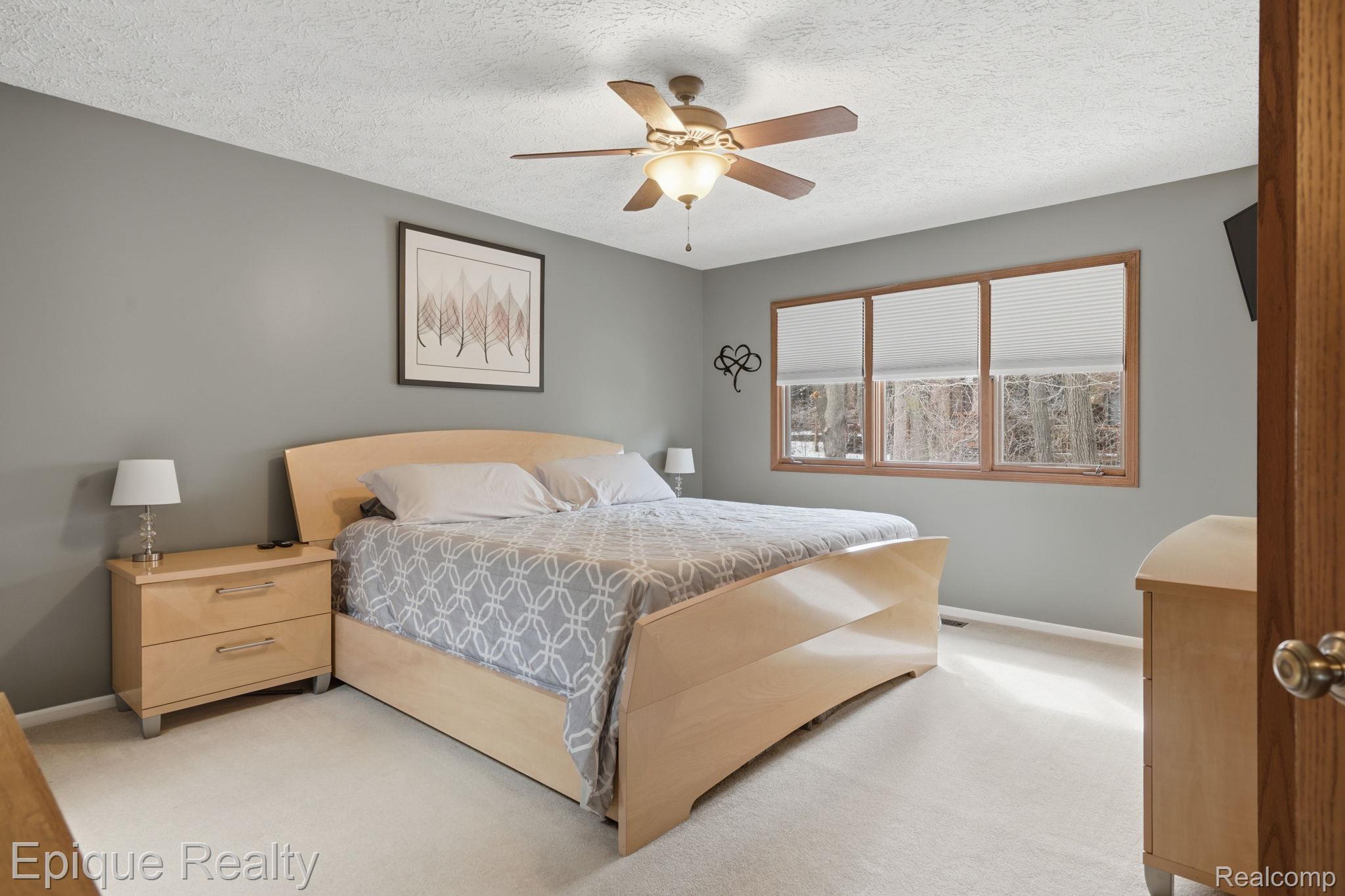 6607 Ridgeview Drive Clarkston, MI 48346 - Photo 20 of 25 Bedroom with ceiling fan, a textured ceiling, and carpet flooring