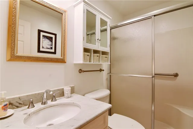 a bathroom with a sink toilet and shower