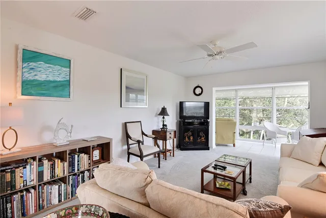 a living room with furniture a window and a flat screen tv