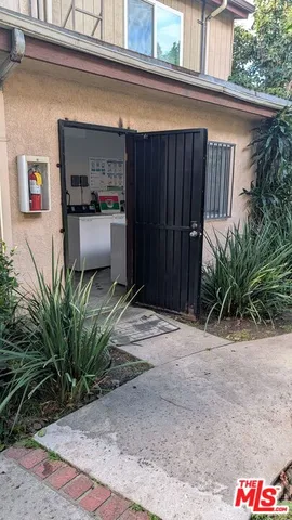a couple of potted plants in front of door