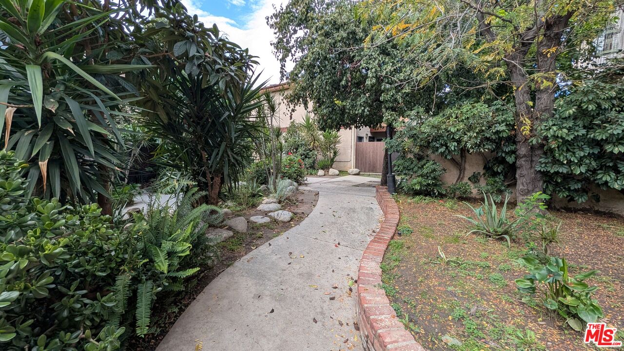 7300 Lennox Avenue, Unit J15 Van Nuys, CA 91405 - Photo 22 of 25 a view of a pathway with a bench