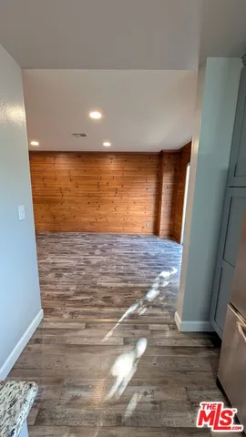 a view of an empty room and wooden floor