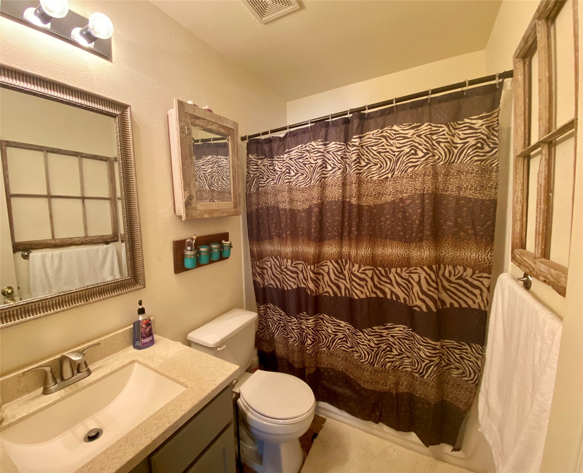 14420 Cummins Way Manor, TX 78653 - Photo 11 of 20 Bathroom featuring a built-in vanity with an undermount sink, a countertop, and a toilet