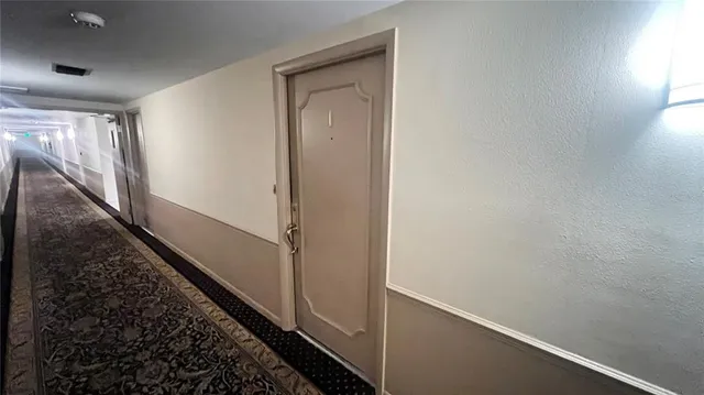 a view of a hallway with paintings on the wall