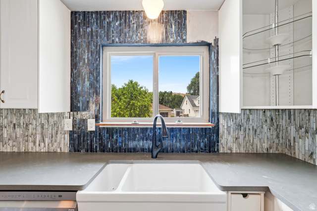 1410 Sumac Drive Logan, UT 84321 - Photo 6 of 28 Kitchen sink area featuring a white double farmhouse sink, a black gooseneck faucet, and dark grey countertops