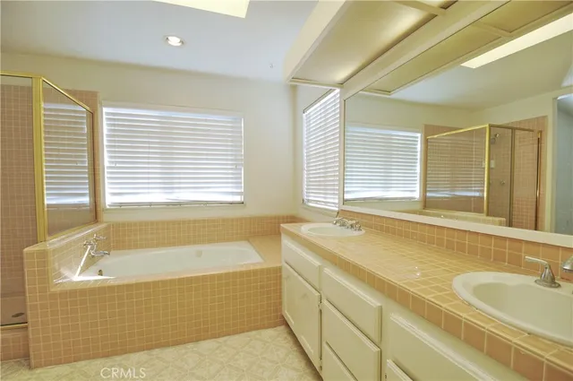 a bathroom with a tub sink and mirror