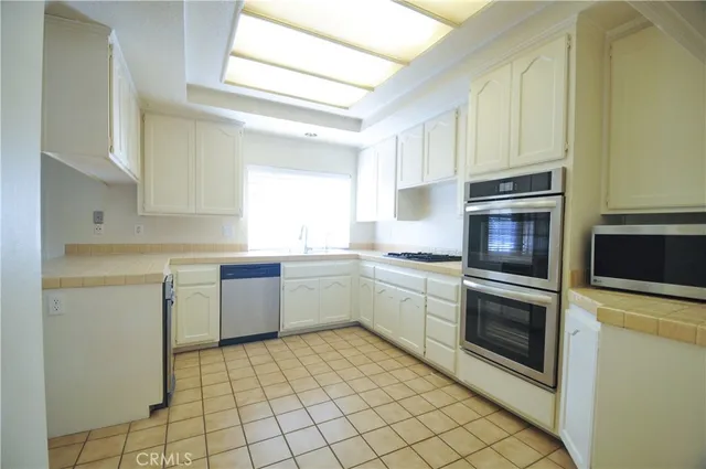 a kitchen with a sink cabinets and stainless steel appliances