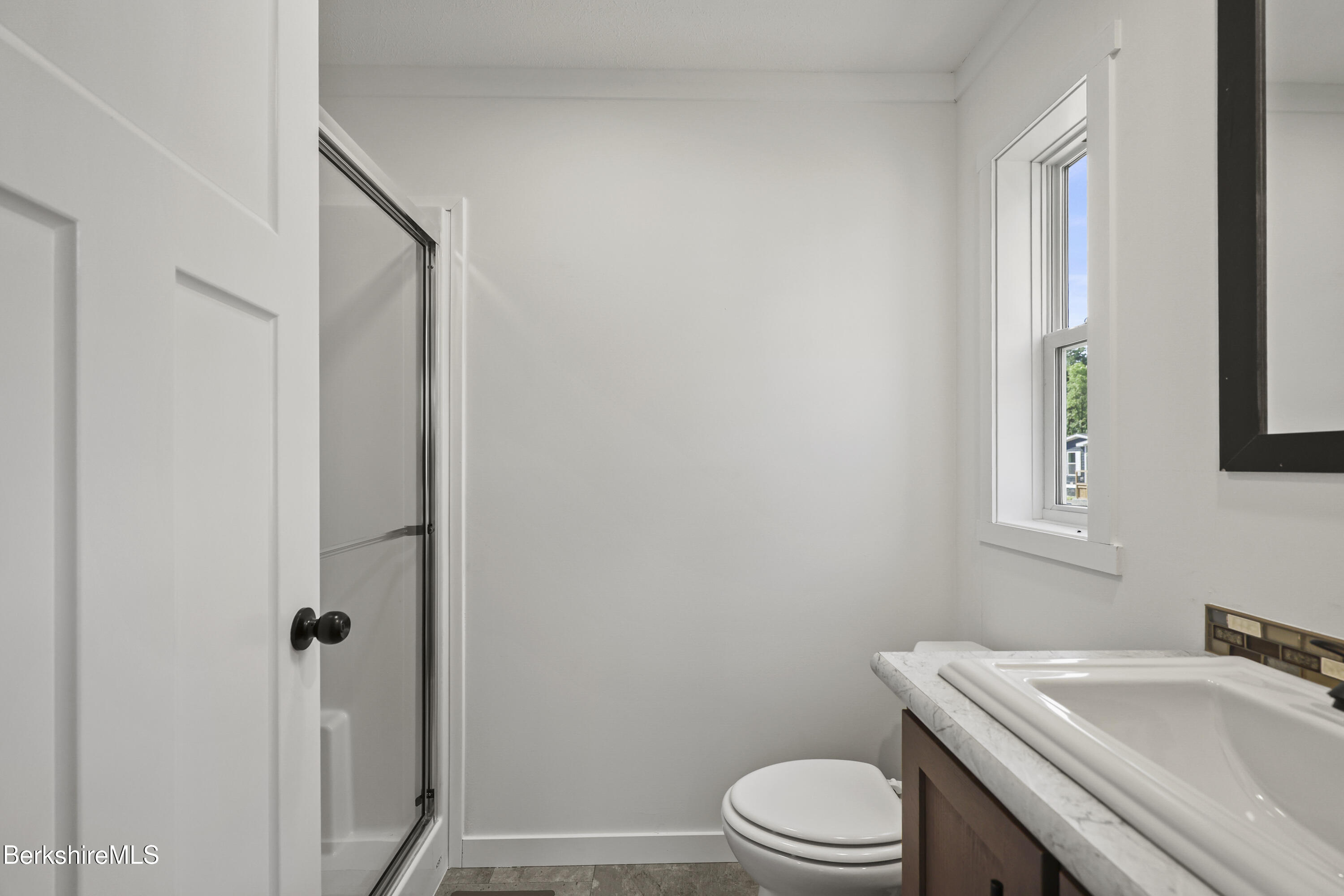 395 Cheshire Road, Unit 102 Pittsfield, MA 01201 - Photo 20 of 28 a bathroom with a sink toilet and vanity