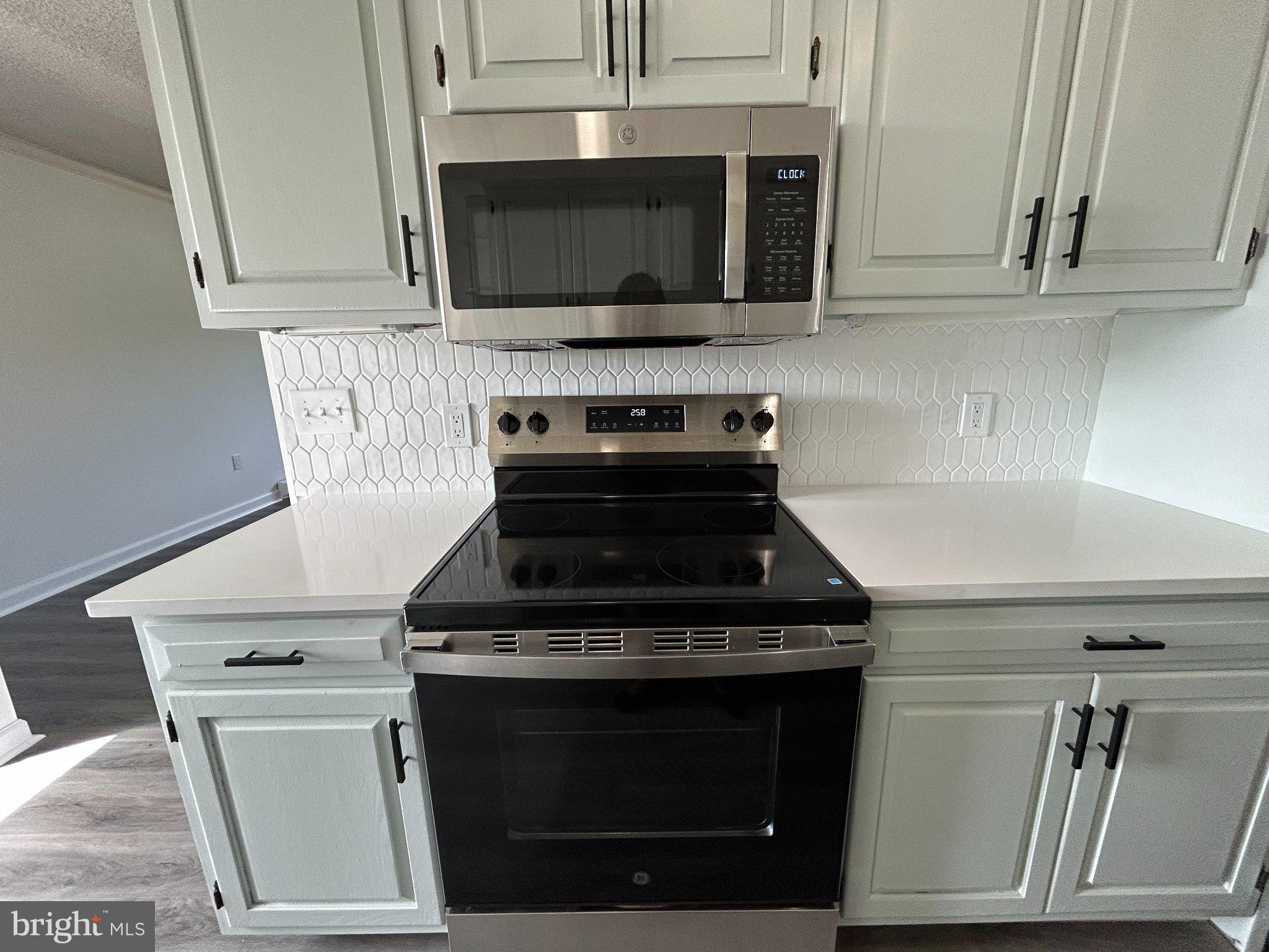 860 Lower Ferry Road, Unit 6M Ewing, NJ 08628 - Photo 7 of 16 a stove top oven sitting inside of a kitchen