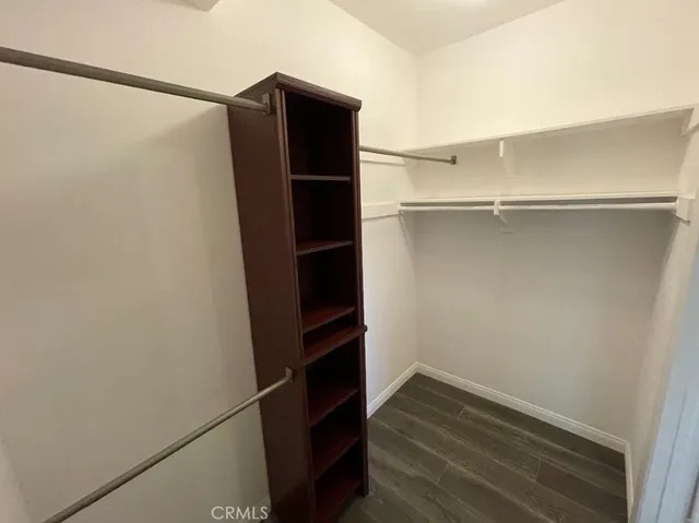 a view of walk in closet with empty racks