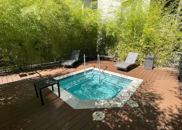 swimming pool view with a seating space