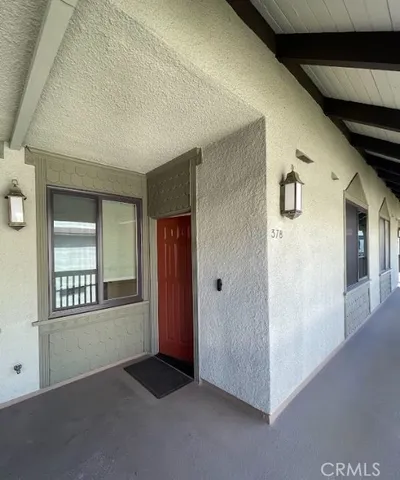 an empty room with windows & cabinet