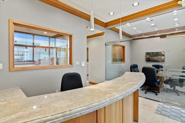 a dining room with furniture a large window and a projector view