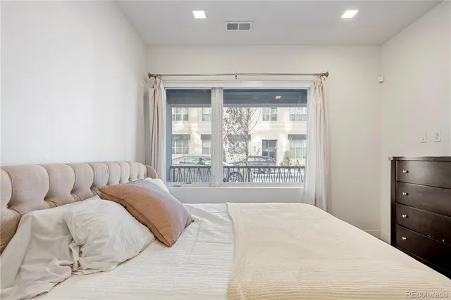 a living room with a bed and a large window