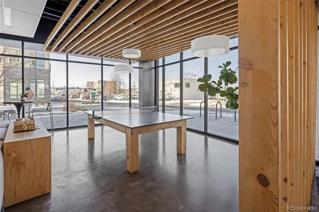 a hallway with a dining table and chairs with wooden floor