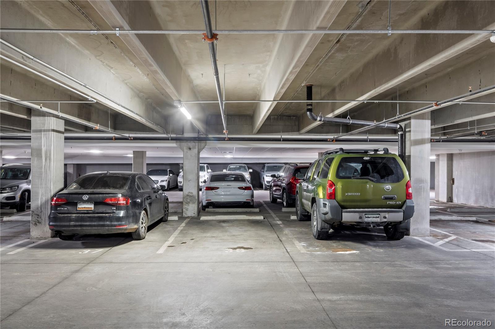 1898 South Bannock Street, Unit 103 Denver, CO 80223 - Photo 22 of 22 a view of parking garage with cars