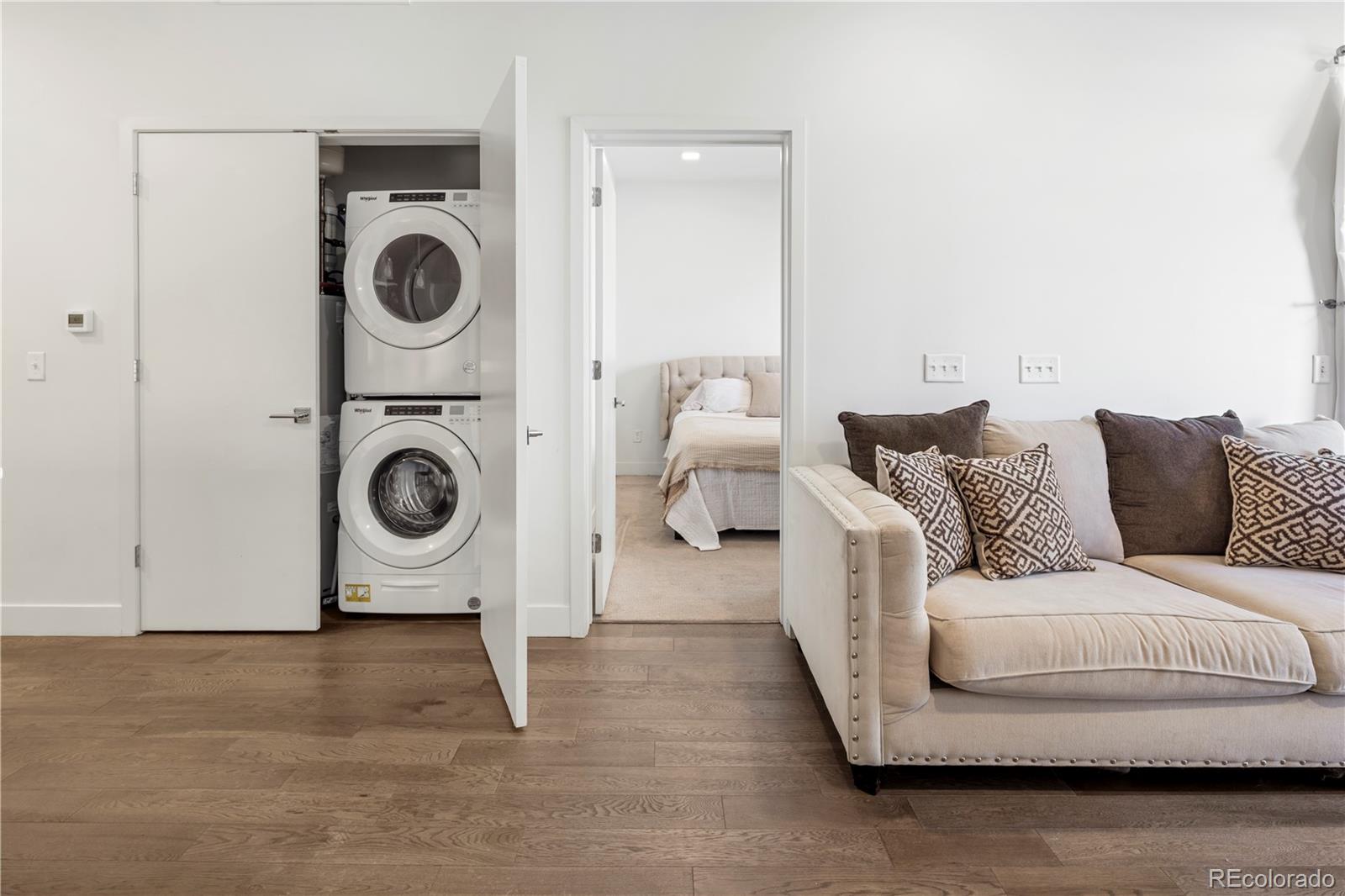 1898 South Bannock Street, Unit 103 Denver, CO 80223 - Photo 5 of 22 a living room with furniture and a washer dryer