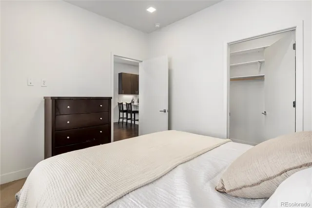 a bedroom with a bed and a dresser