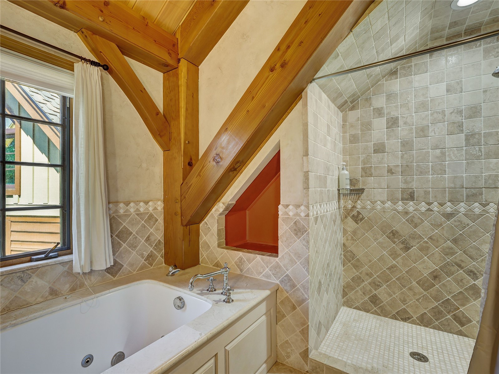 840 Penstemon Road Keystone, CO 80435 - Photo 19 of 50 Bathroom with tile walls, a jetted tub, and tiled shower