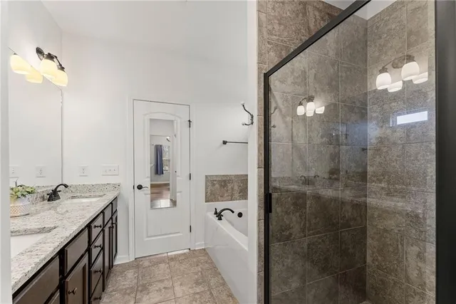 a bathroom with a granite countertop sink a shower and a mirror