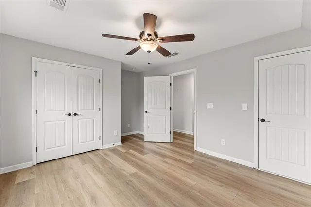a view of empty room with wooden floor