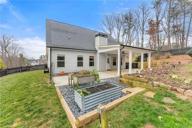 a view of a house with backyard and sitting area