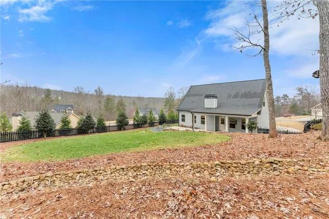 a view of house with a yard