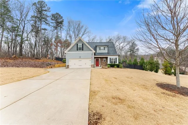 a front view of a house with a yard covered in snow