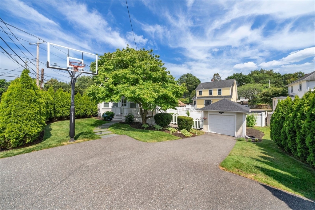 1111 Brook Road Milton, MA 02186 - Photo 20 of 22 a view of a house with a yard and potted plants