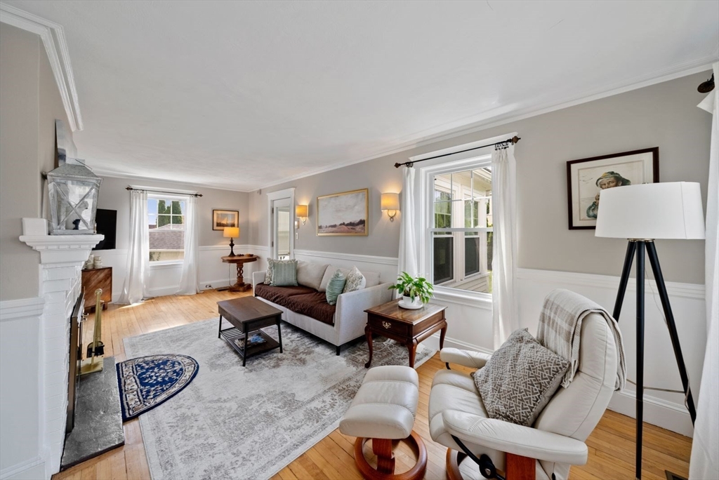 1111 Brook Road Milton, MA 02186 - Photo 2 of 22 a living room with furniture a fireplace and a window