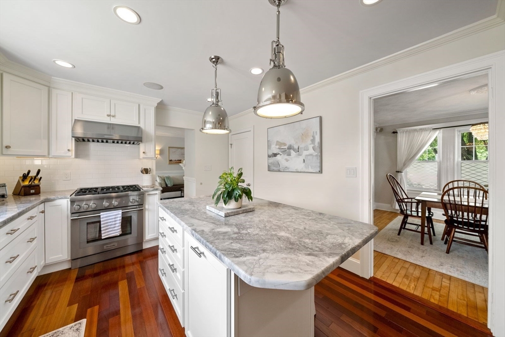 1111 Brook Road Milton, MA 02186 - Photo 4 of 22 a kitchen with granite countertop kitchen island stainless steel appliances a stove a sink a oven a dining table and chairs