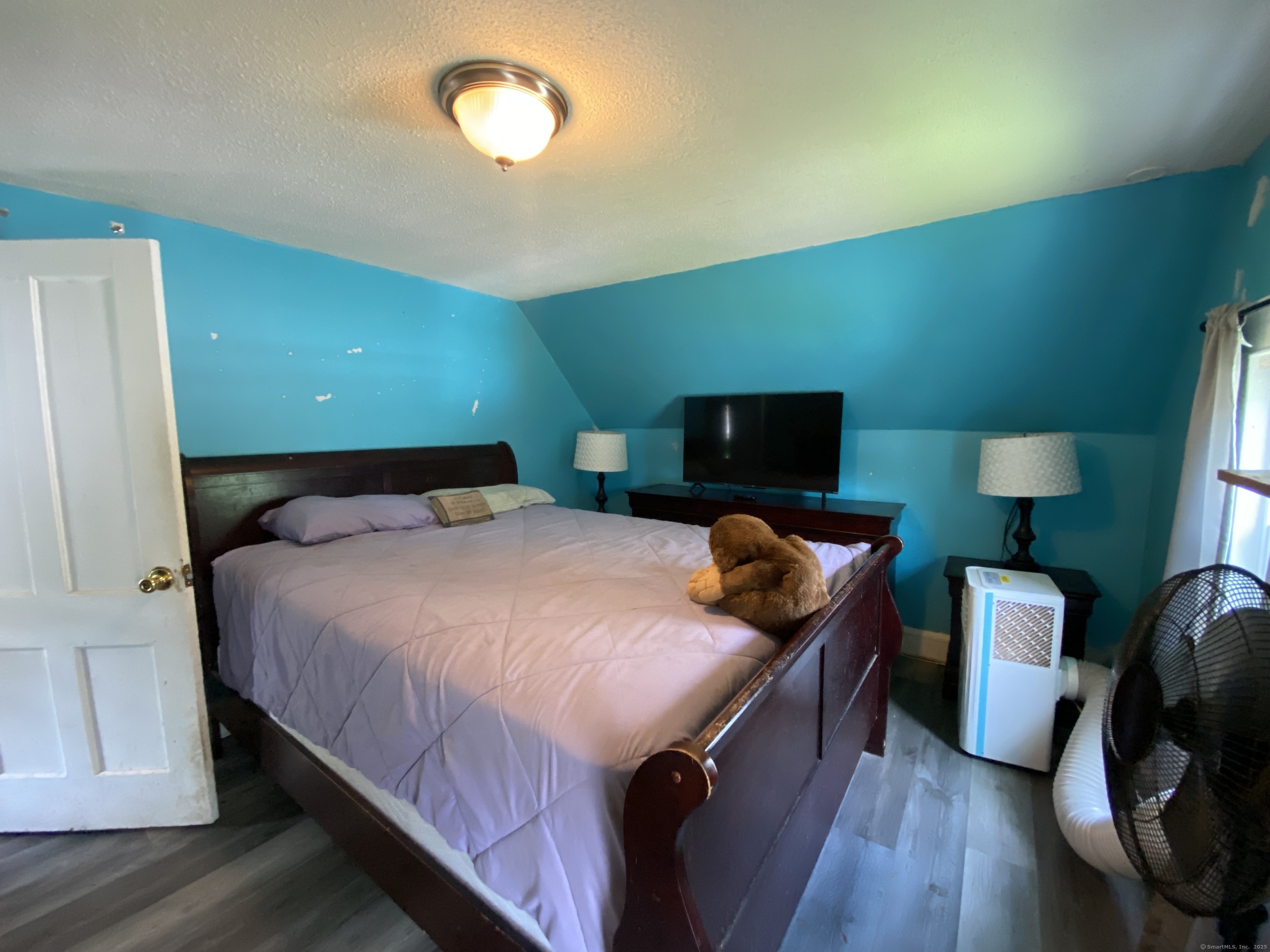 148 Hillside Avenue Torrington, CT 06790 - Photo 16 of 38 a bedroom with a bed and a flat screen tv