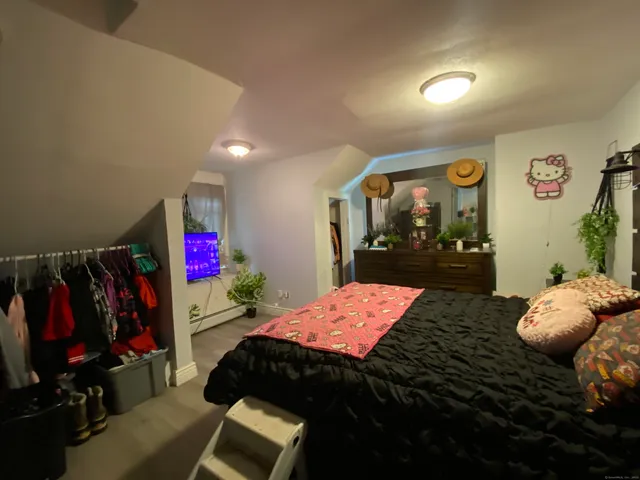a bedroom with a bed and a dresser