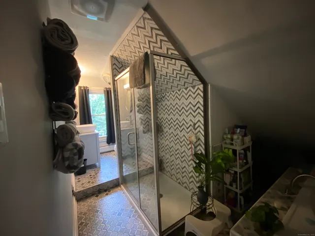 a white toilet sitting next to a bathroom sink and a mirror