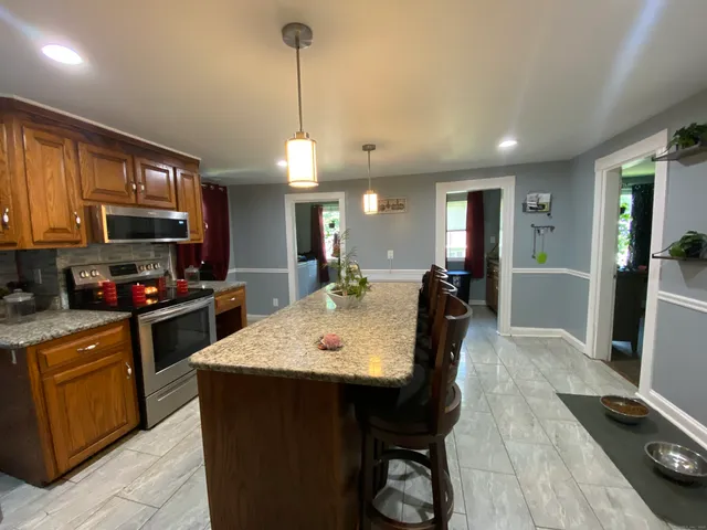 a large kitchen with a table and chairs