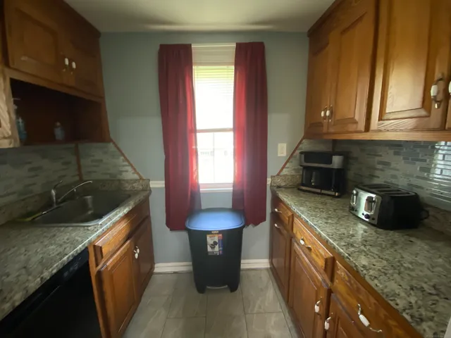 a kitchen with stainless steel appliances granite countertop sink stove and cabinets