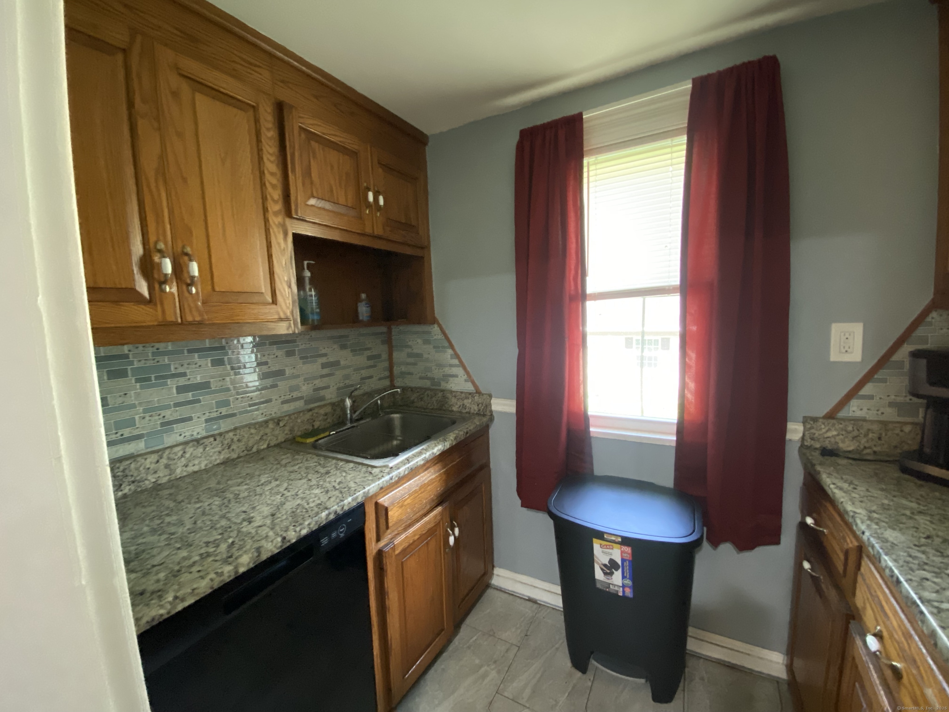 148 Hillside Avenue Torrington, CT 06790 - Photo 9 of 38 a kitchen with granite countertop a sink stove and cabinets