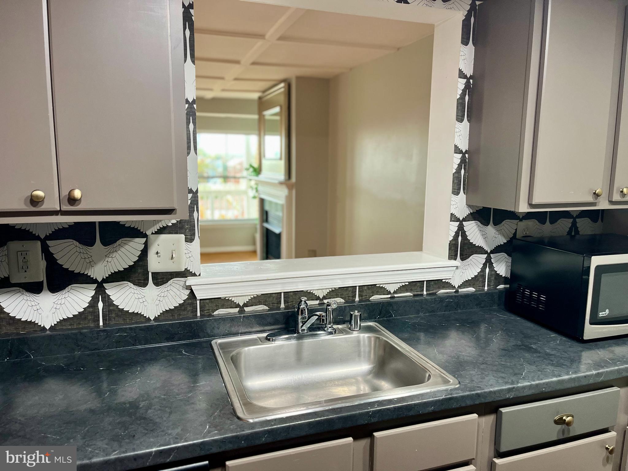 2609 Douglass Road Southeast, Unit 402 Washington, DC 20020 - Photo 13 of 35 a kitchen with a sink and a window