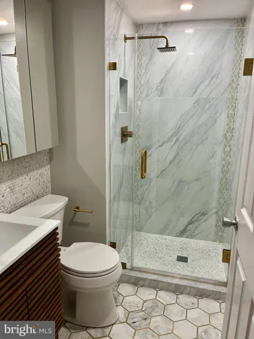 a bathroom with a toilet and a shower